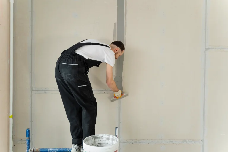 full-shot-construction-worker-using-plastering-trowel